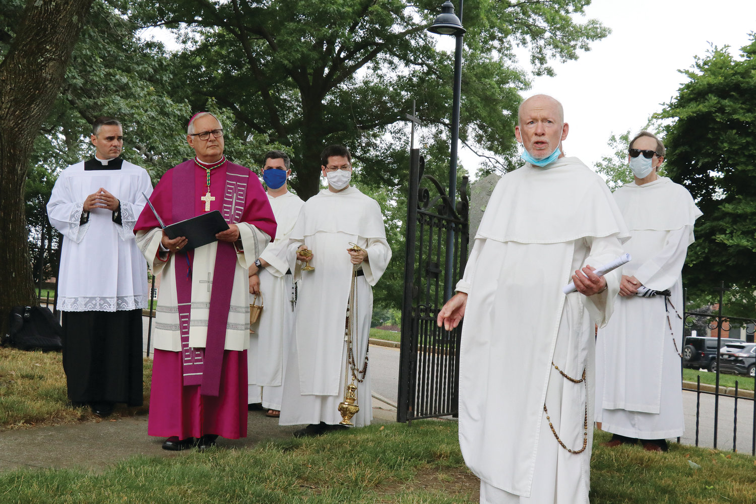 As Bishop Tobin looks on, Father Brian Shanley, O.P., president of Providence College, asks for prayers for the man who vandalized the Dominican Cemetery before attacking and injuring a campus police officer on June 22.